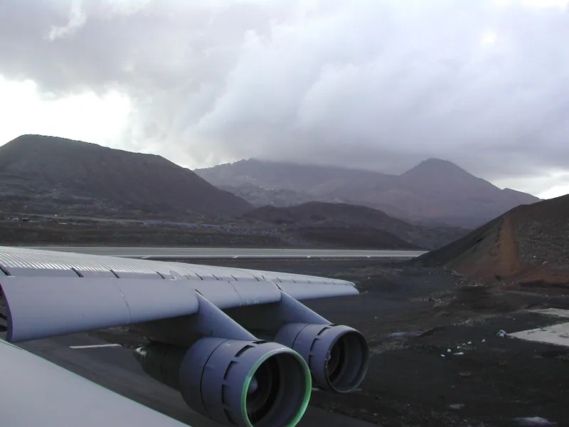 Mountains under the wing of a C-5 Galaxy in flight, photographed from the crew position