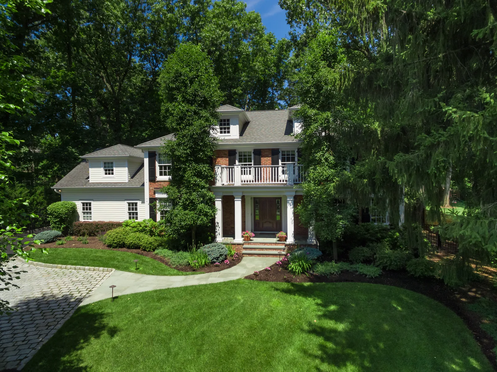 Elevated front view of a Chatham, NJ colonial framed by mature trees