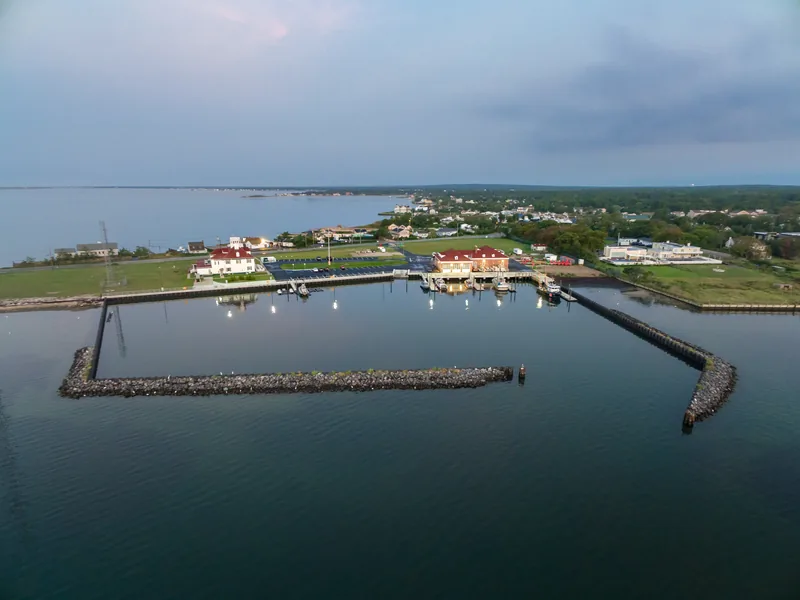 Dusk aerial of a U.S. Coast Guard station and its protected boat basin