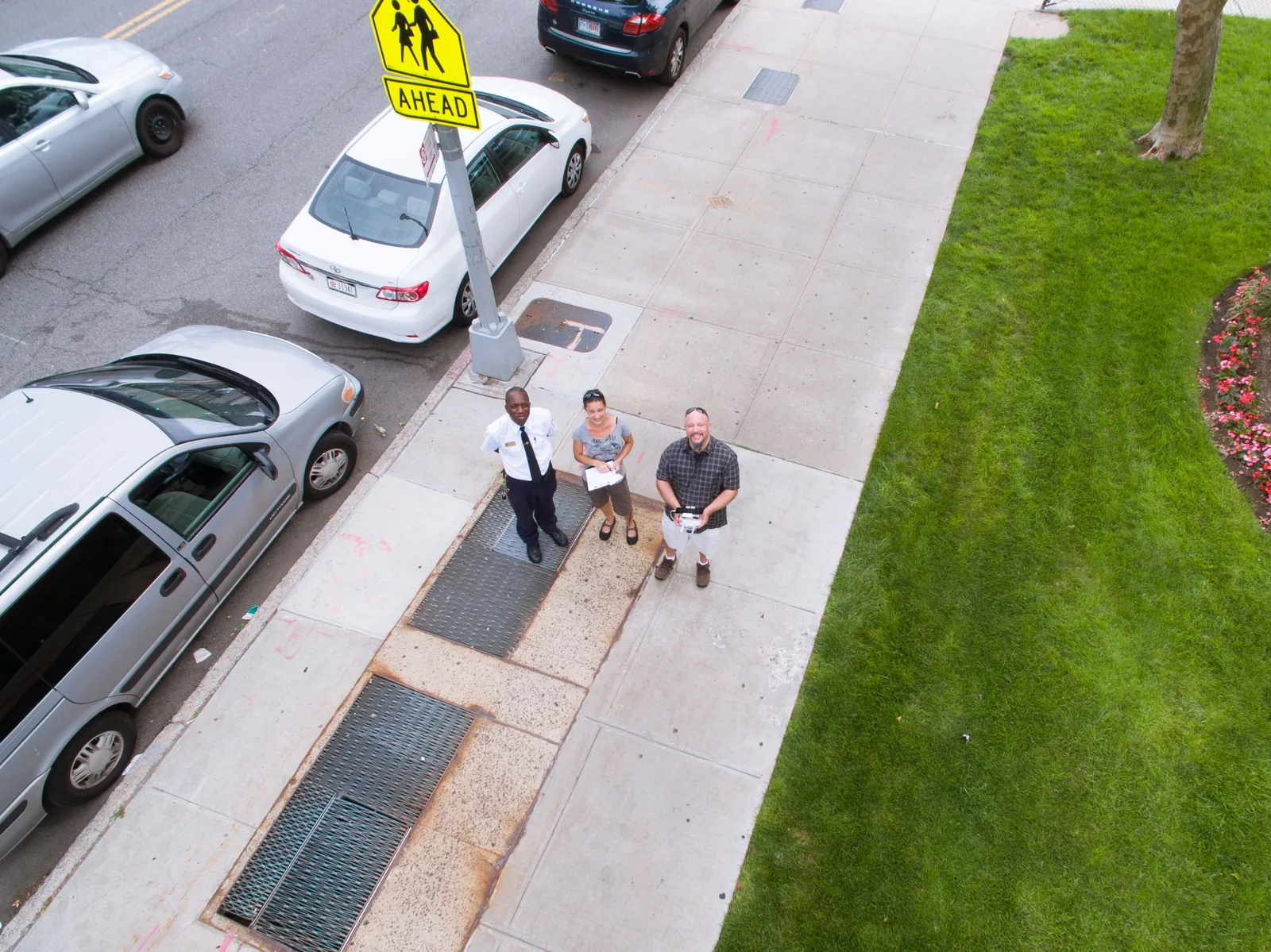 Seen from the drone overhead: the pilot on the controls and the visual observer beside him on a New York City sidewalk