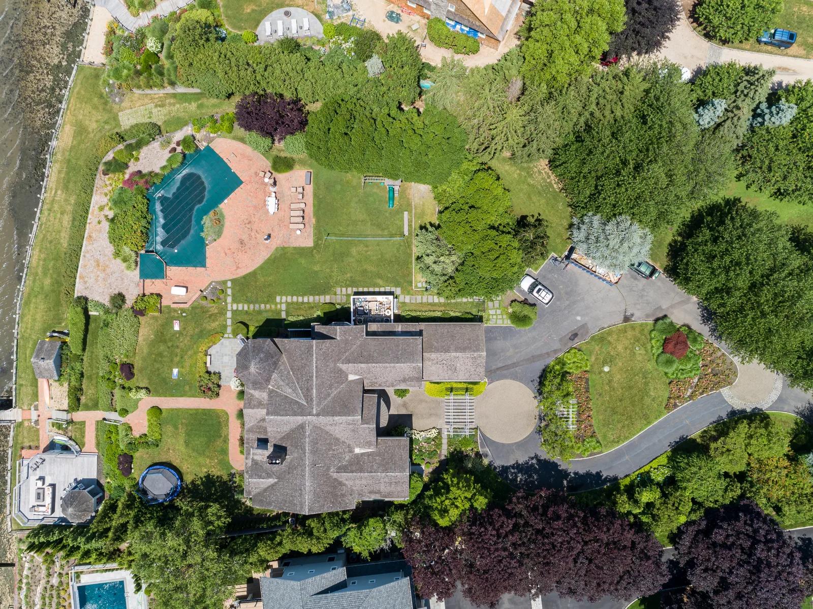 Straight-down overhead of an estate pool, patios, and gardens