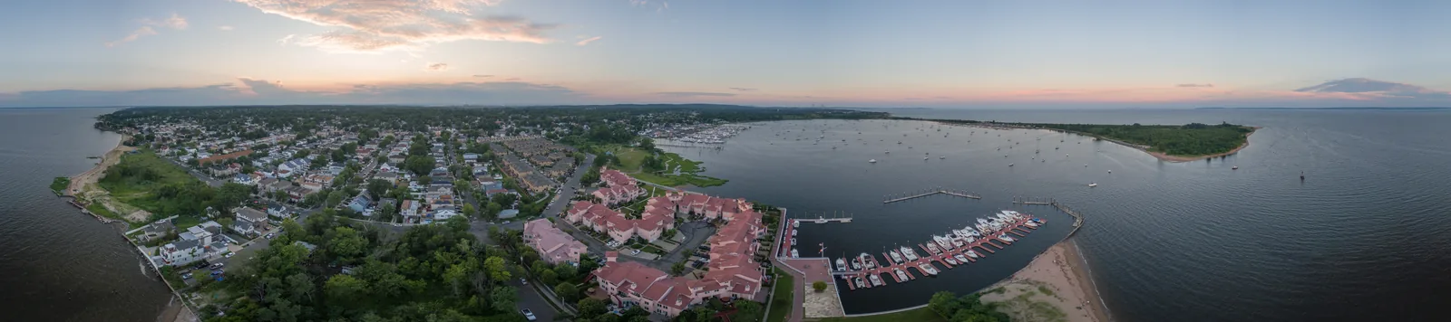Wide aerial panorama of a marina — slips, fairways, and open water