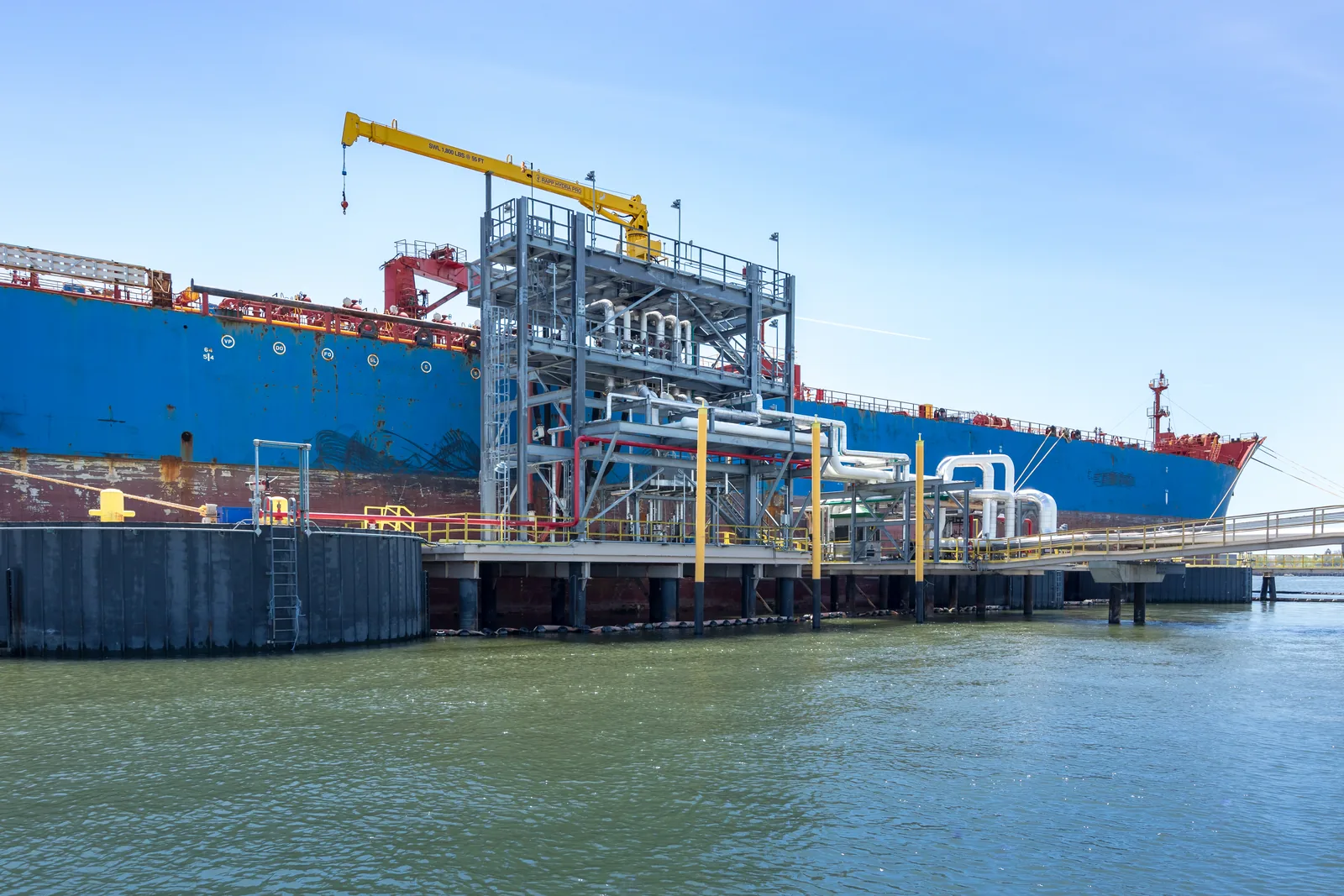 Tanker alongside a marine terminal loading platform, photographed from the water
