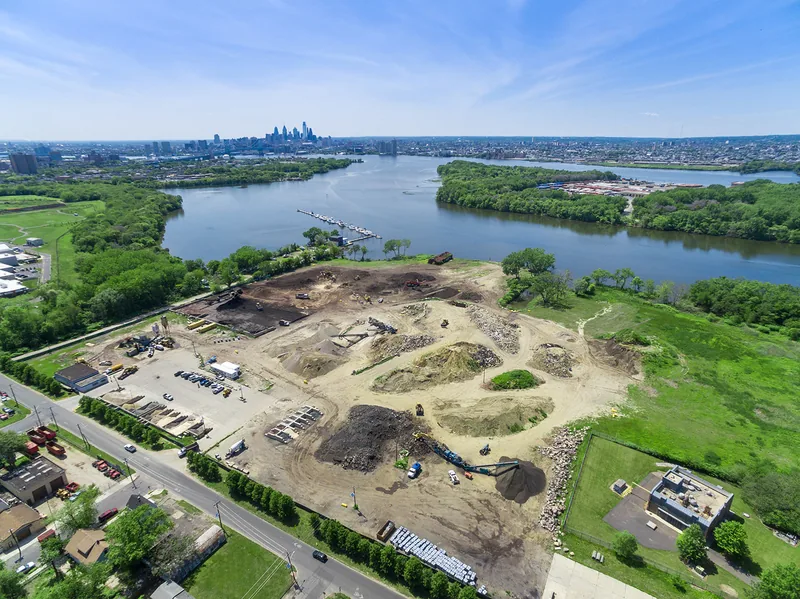 Riverfront industrial site in Camden, NJ, with the Delaware River and the Philadelphia skyline beyond