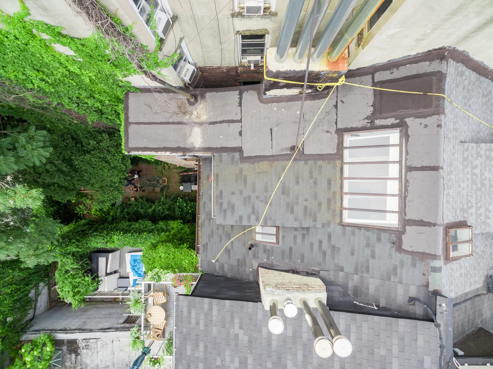 Overhead drone view of a building roof, skylights, and rooftop equipment, captured for an architecture firm