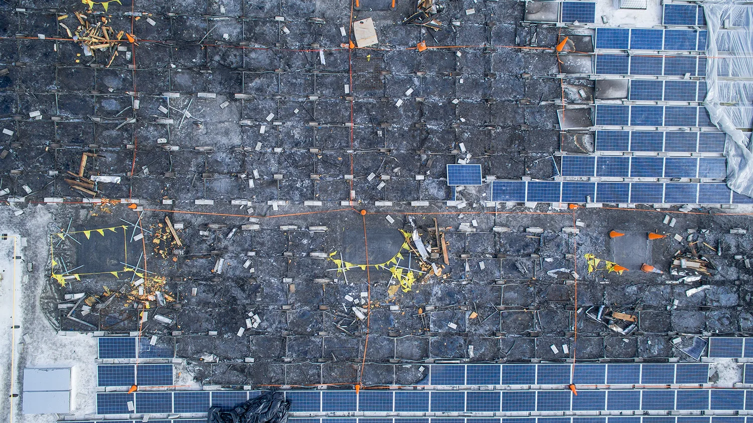 Overhead detail of burned solar panels and roof debris, captured for the damage record