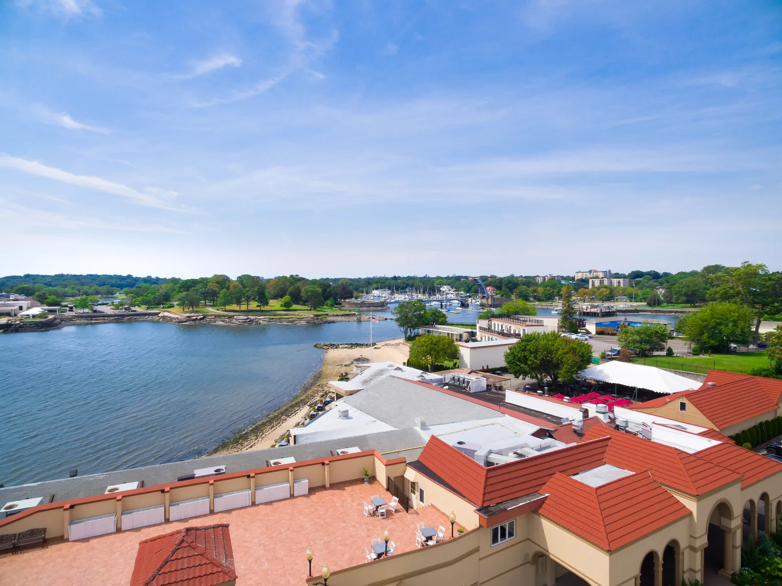 Waterfront club and harbor with docks and open water beyond